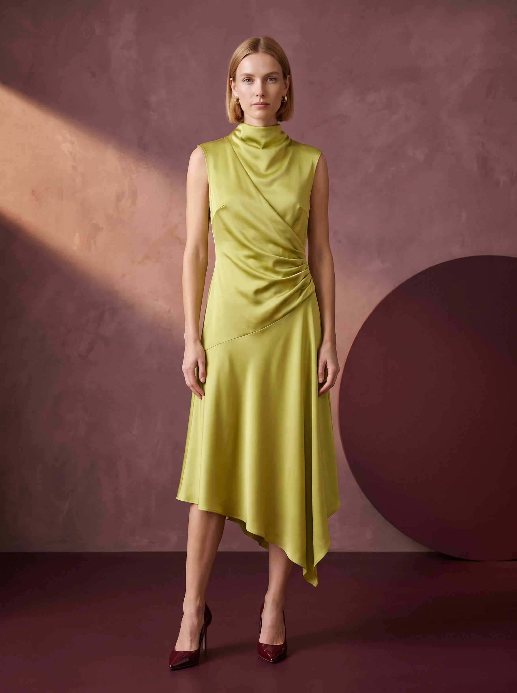 Front campaign concept: the same model wearing the pista satin midi dress in a plum studio