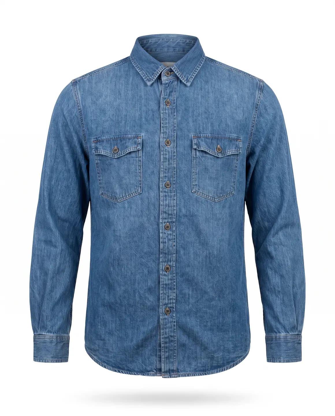 A blue denim shirt with two flap chest pockets, floating on white with a soft shadow beneath