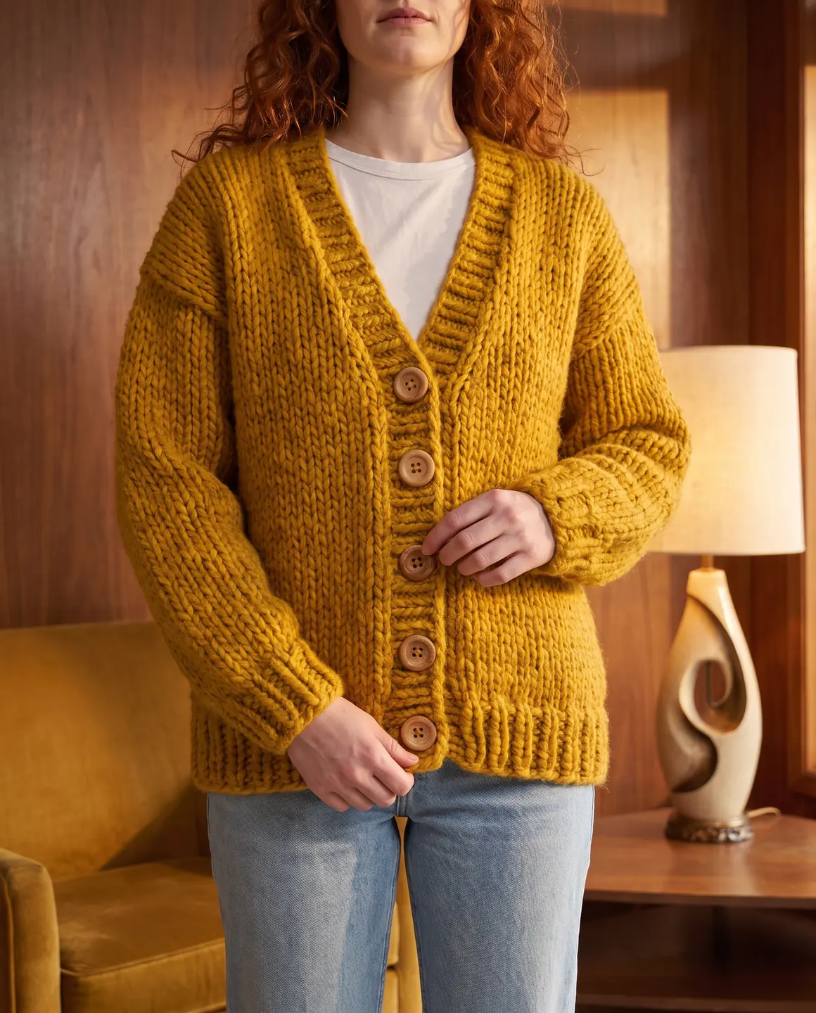 Mustard chunky-knit cardigan with wooden buttons, worn over a white T-shirt