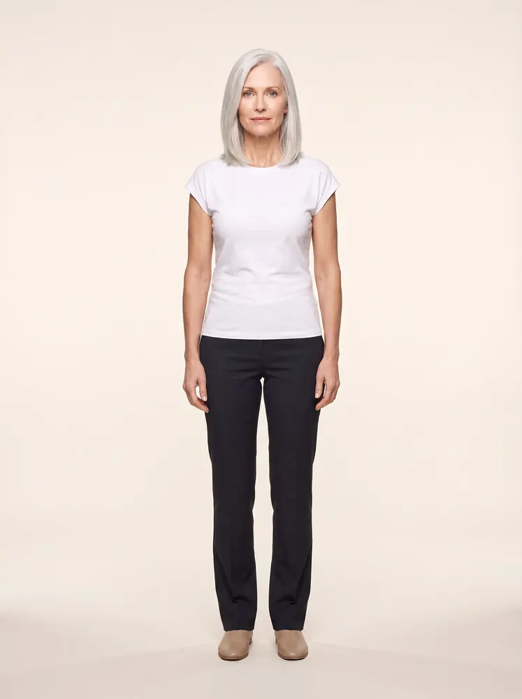 Ingrid, a fictional AI model: full length, with a silver lob, in a white tee and dark trousers