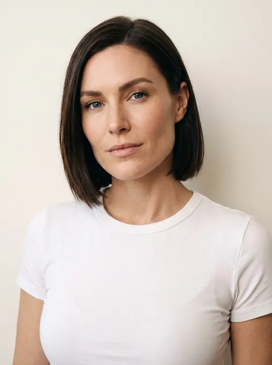 Katarina, a fictional AI model: a woman with a sleek dark bob, in a white tee