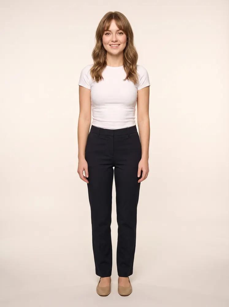 Lily, a fictional AI model: full length, a petite model with curtain bangs, in a white tee and dark trousers