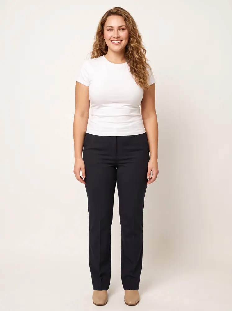 Nell, a fictional AI model: full length, a curve model with long curly hair, in a white tee and dark trousers