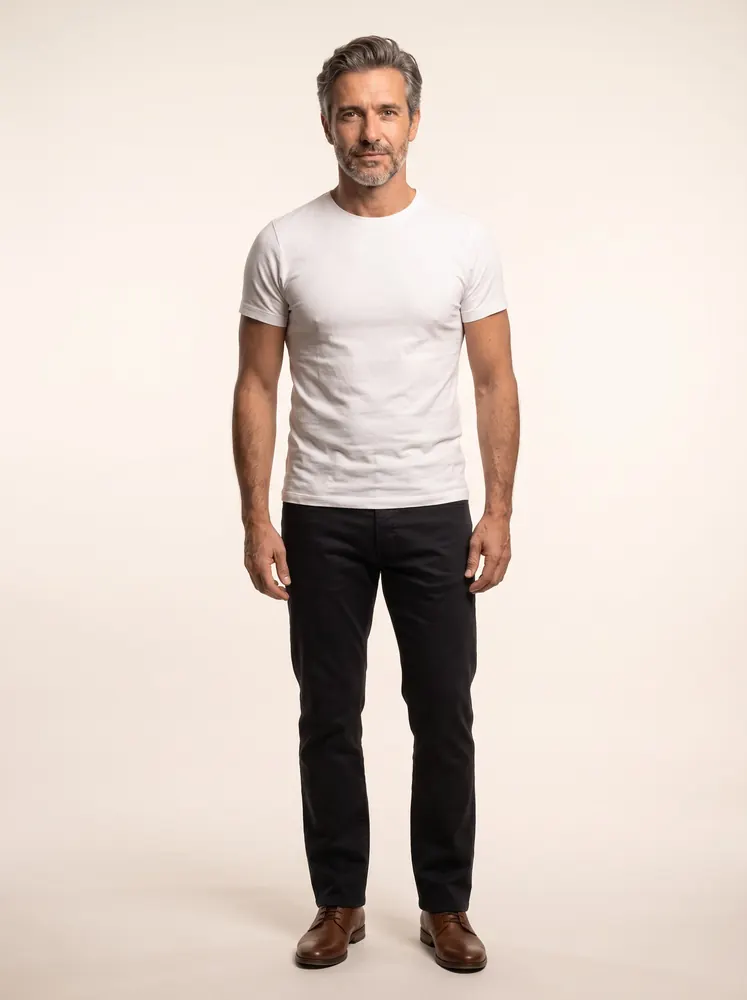 Rafael, a fictional AI model: full length, with silver hair and a grey beard, in a white tee and dark trousers
