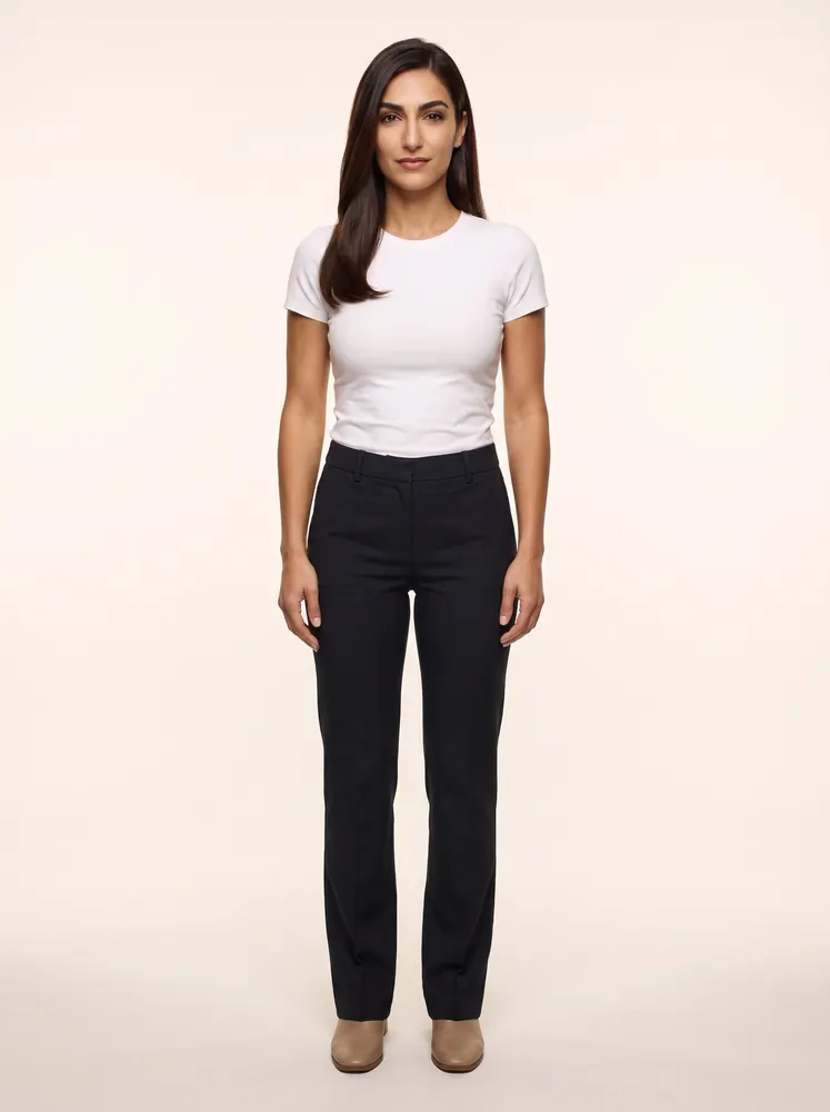 Valentina, a fictional AI model: full length, with long dark hair, in a white tee and dark trousers
